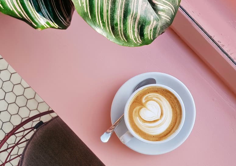 coffee cup on pink desk